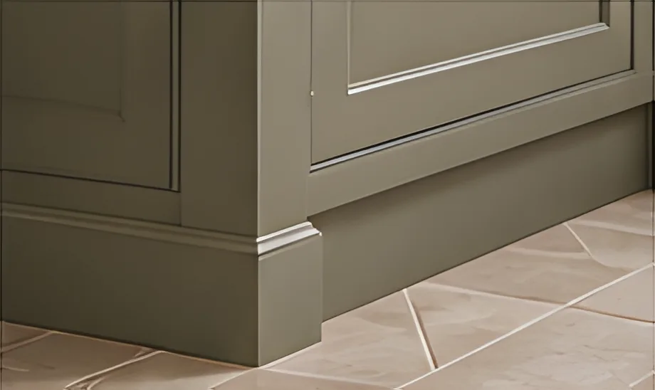 Sage end panel and plinth meeting a stone tiled floor